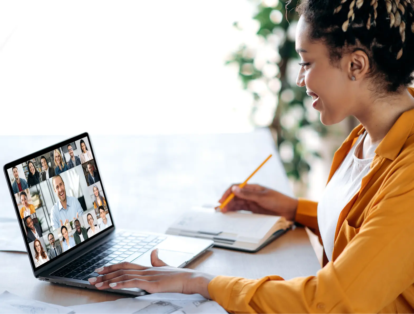 Lady smiling in front of laptop during team meeting
